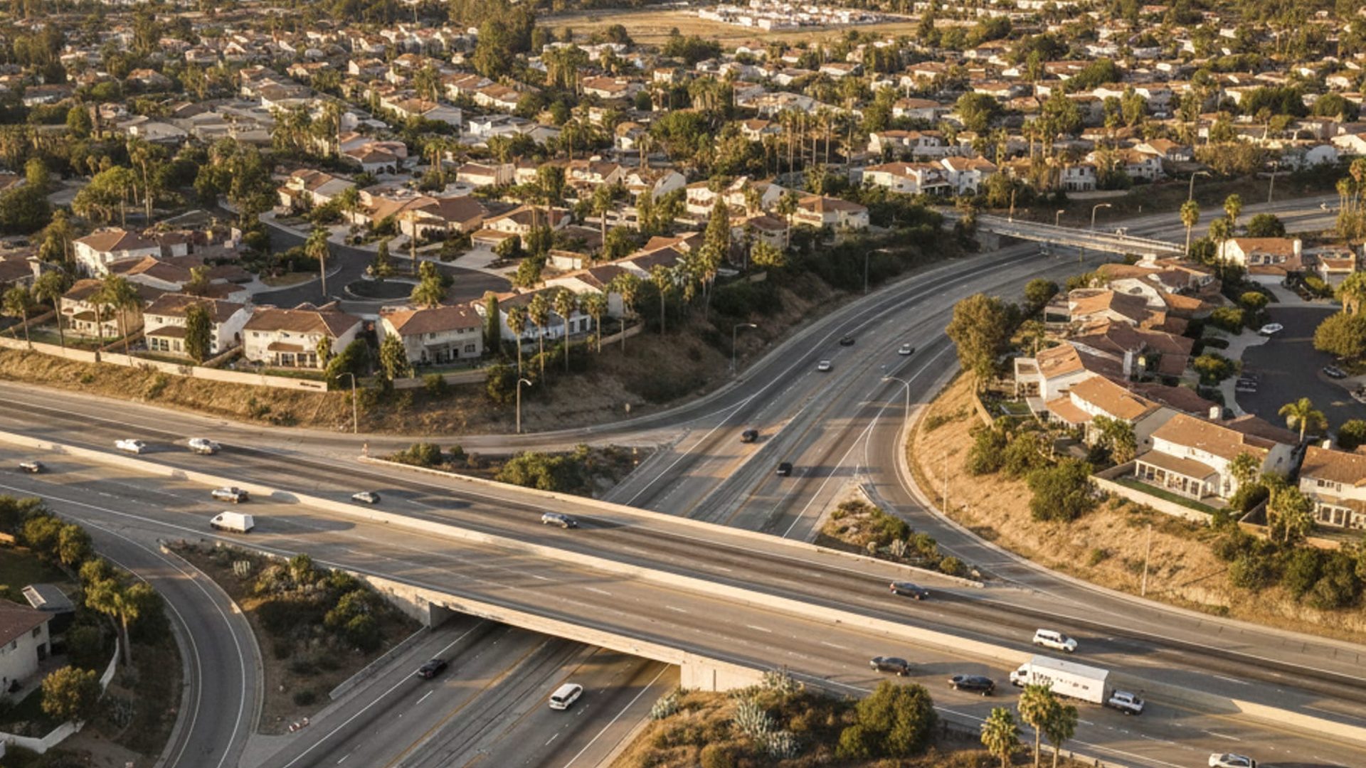 Freeway interchange winding between neighborhoods in the late afternoon